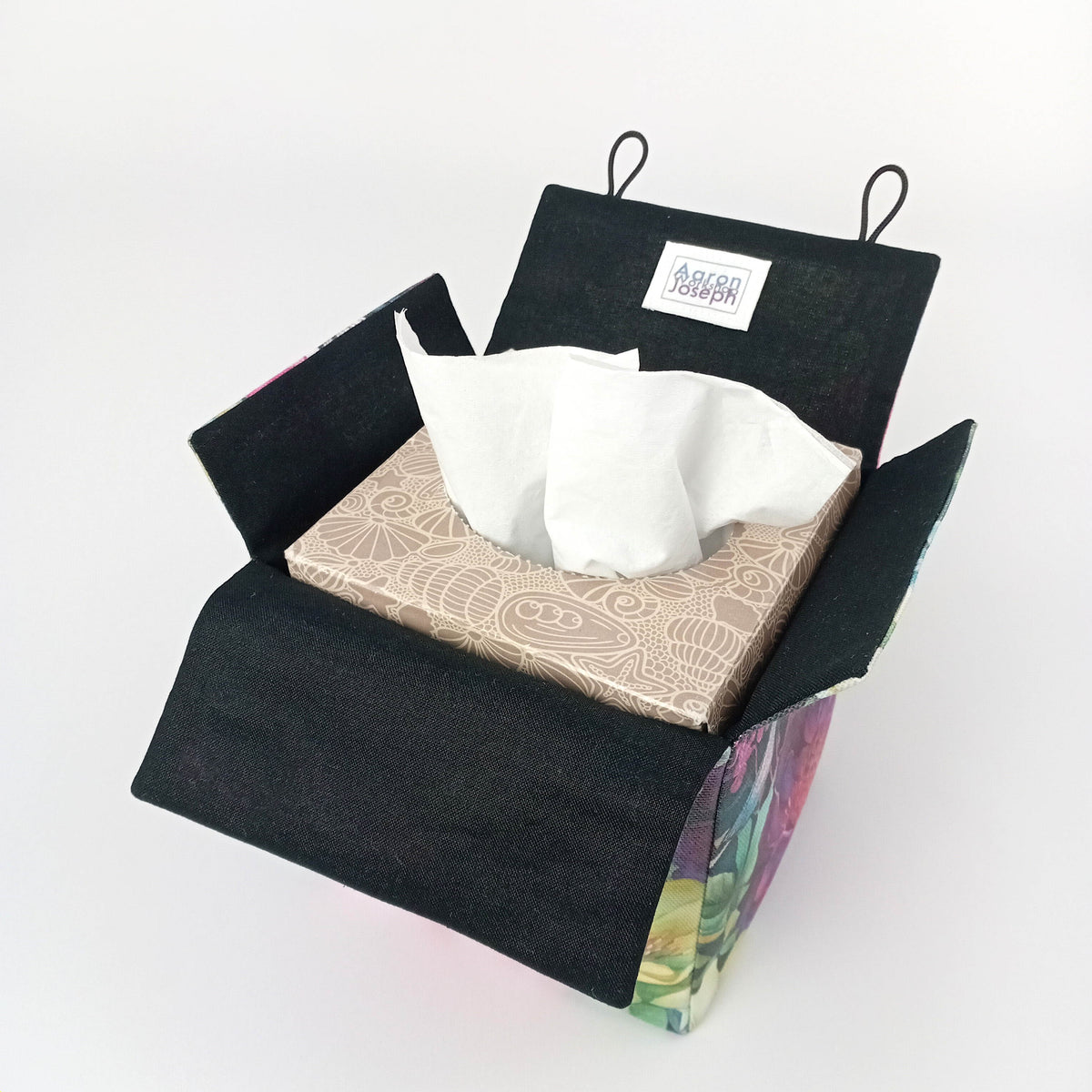 Interior view of a handmade square cotton tissue box cover with a black interior and floral exterior.
