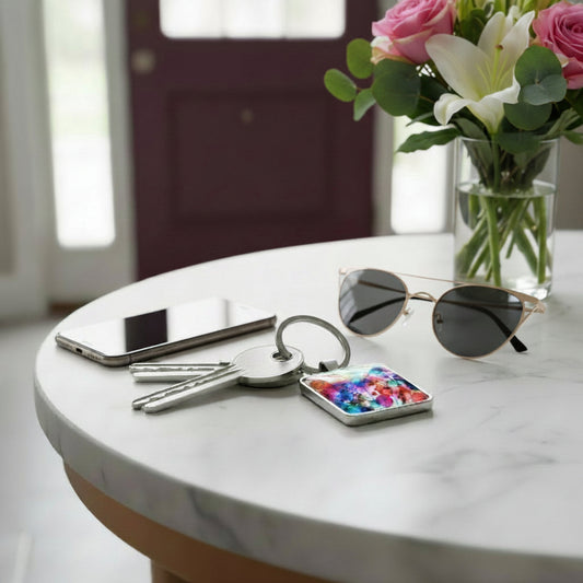 Keychain with a colourful floral design on a console table