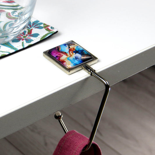 Handbag hook with glass domed image for hanging accessories on tables, ledges, and shelves