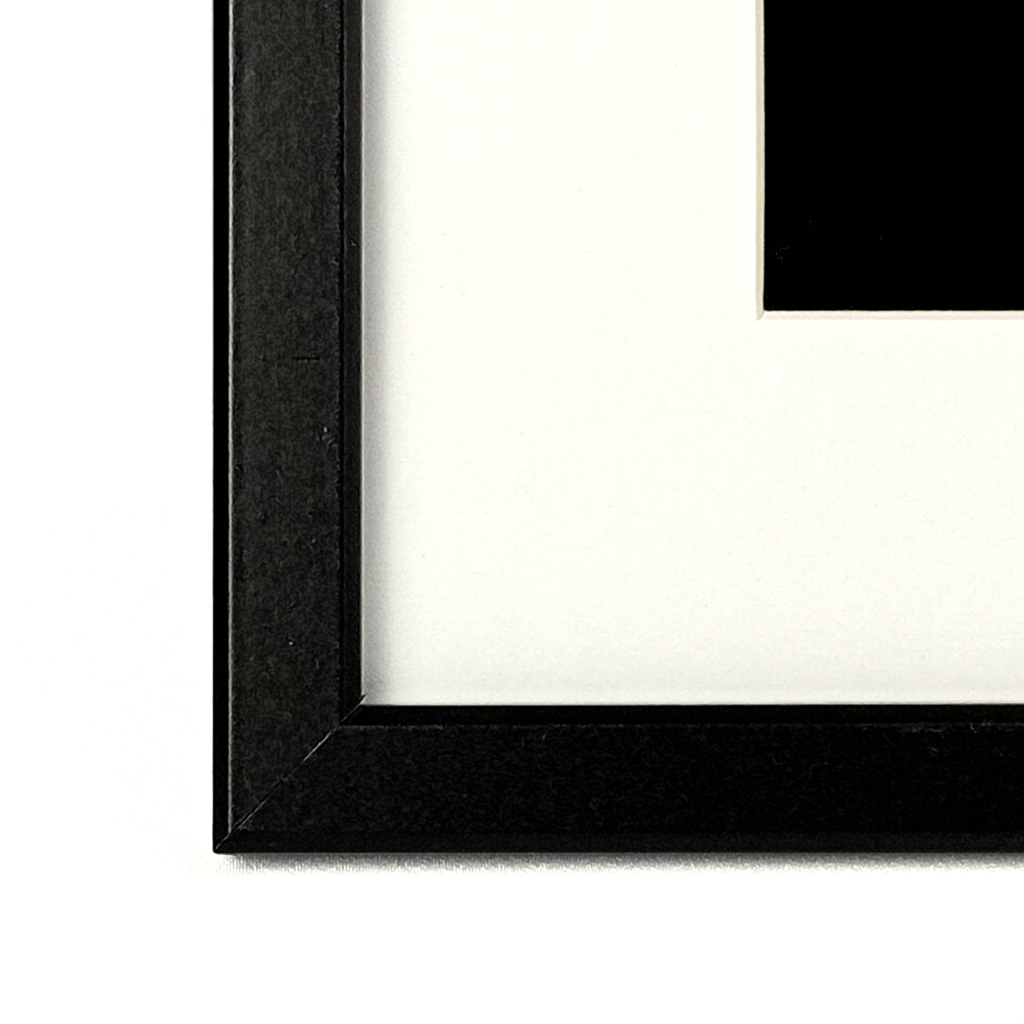 Close up of a bevelled picture frame with white mat