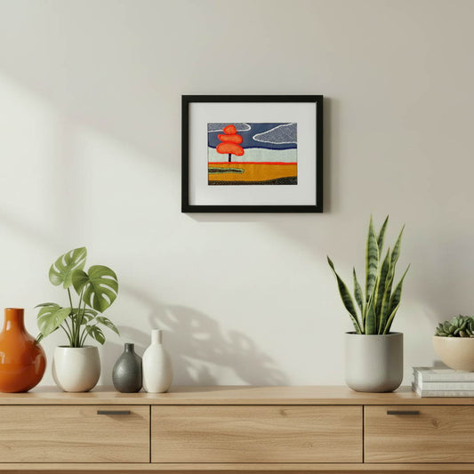 Framed fabric art with single tree in a field landscape