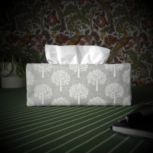Cotton rectangle tissue box cover with a pen, notebook, and plant
