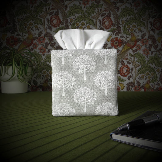 Cotton square tissue box cover with pen, notebook, and plant