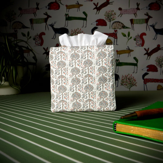 Linen square tissue box cover with pen, notebook, and plant