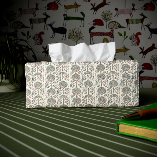 Linen rectangle tissue box cover with a pen, notebook, and plant