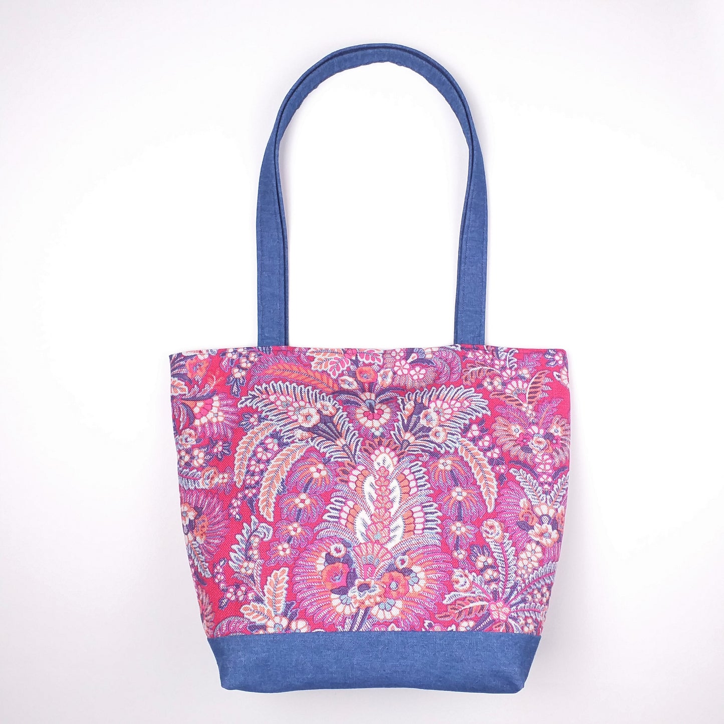 Front view of a large tote bag with multi-colour floral pattern, solid blue denim colour base