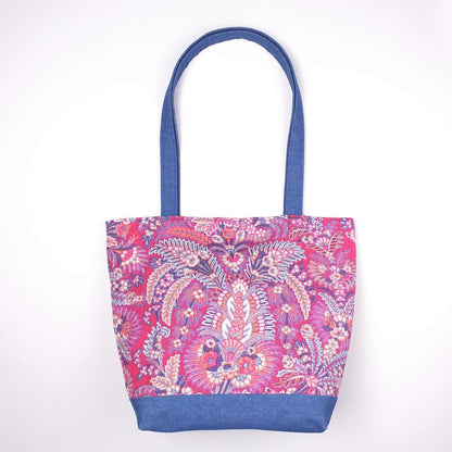 Front view of a large tote bag with multi-colour floral pattern, solid blue denim colour base