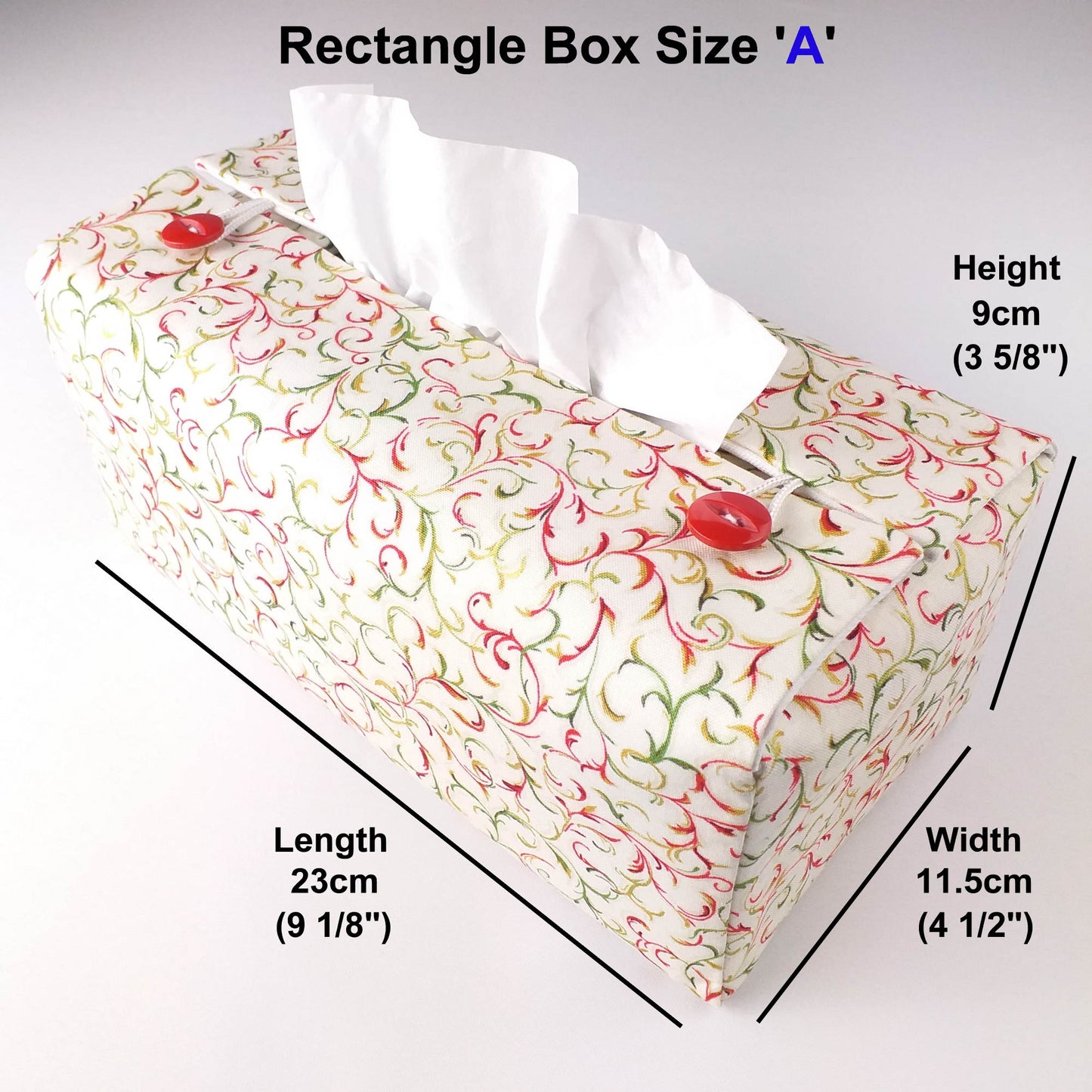 Cotton rectangle tissue box cover with holiday themed red and green swirls with metallic gold accent on off-white background