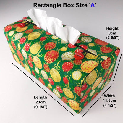 Cotton rectangle tissue box cover with holiday themed red, gold, and white Christmas baubles with metallic gold accent on green background