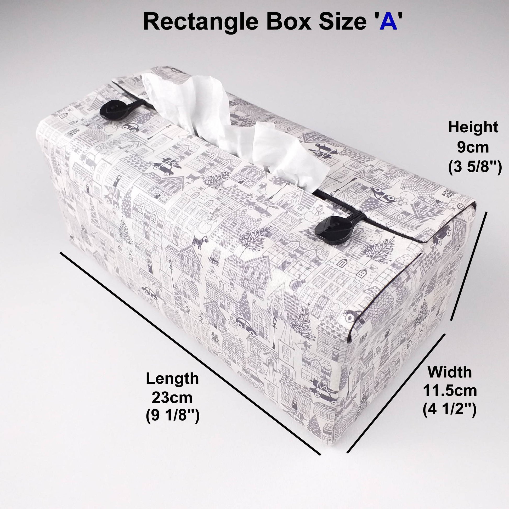 Rectangle tissue box cover with holiday themed winter village scene on off-white background
