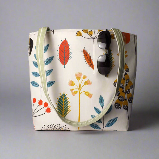 Large tote bag with multi-colour wild flowers design on off-white background