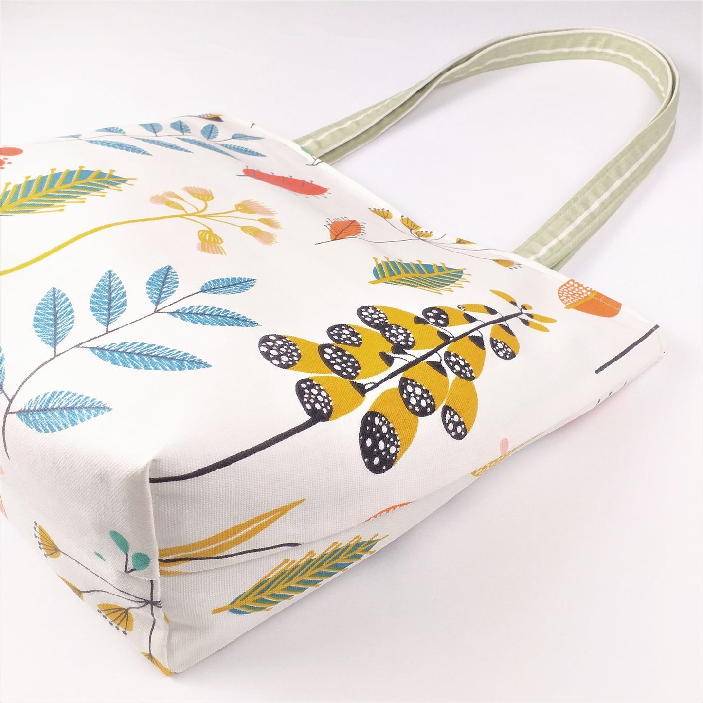 Bottom view of a large tote bag with multi-colour wild flowers design on off-white background