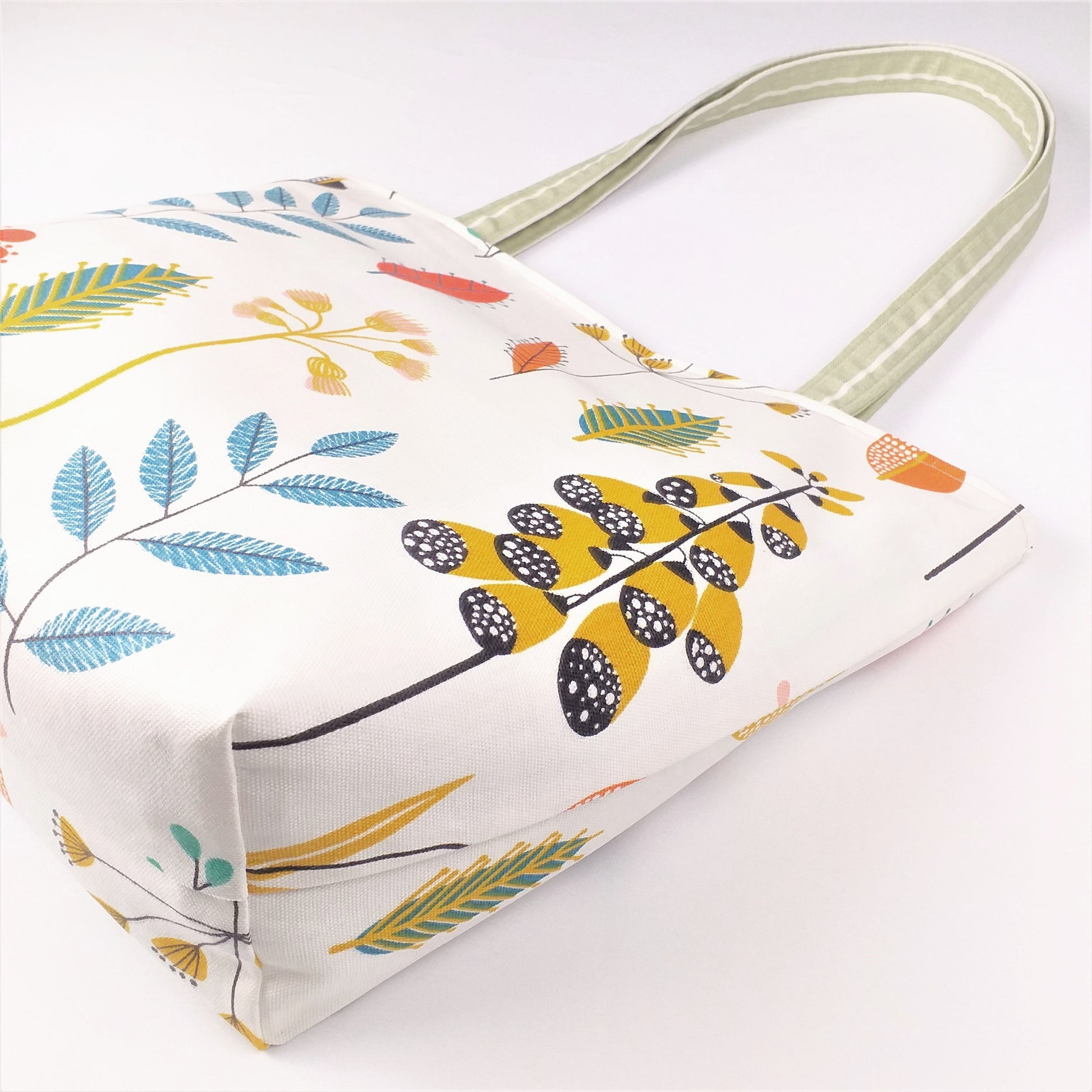 Bottom view of a large tote bag with multi-colour wild flowers design on off-white background