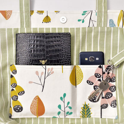 Close up view of a large tote bag interior slip pocket and key clasp