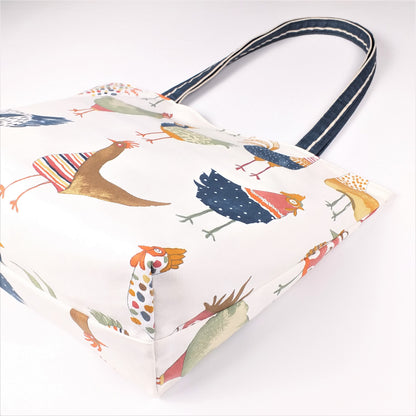 Bottom view of a large tote bag with multi-colour hens design on beige background