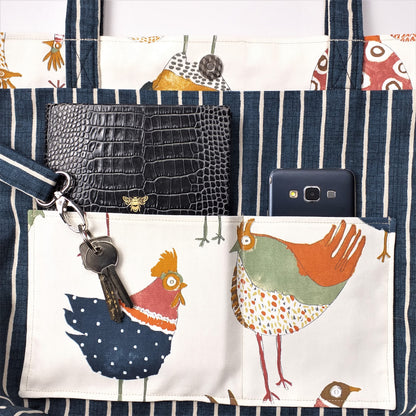 Close up view of a large tote bag interior slip pocket and key clasp