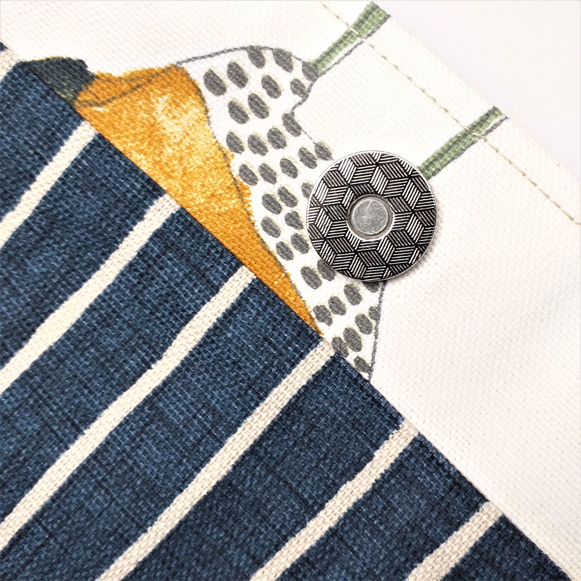 Close up view of a large tote bag magnetic closure