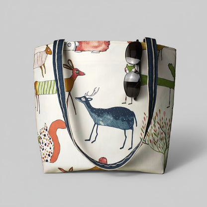 Handmade cotton large tote bag with multi-colour forest animals design on off-white background, including shoulder straps