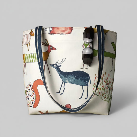 Handmade cotton large tote bag with multi-colour forest animals design on off-white background, including shoulder straps