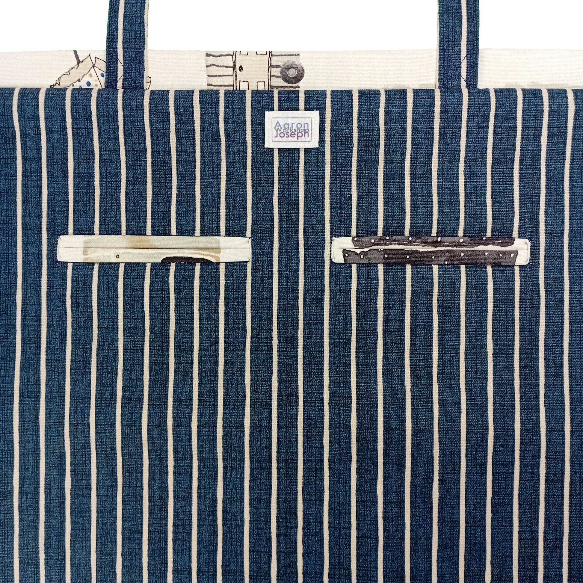 Close up view of a large tote bag interior with 2 double welt pockets