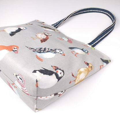 Bottom view of a large tote bag with multi-colour puffins design on grey background