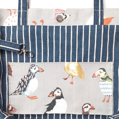 Close up view of a large tote bag interior slip pocket and key clasp