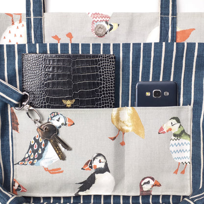 Close up view of a large tote bag interior slip pocket and key clasp