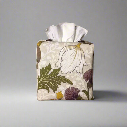 Square tissue box cover with white magnolia flowers design with green, yellow, and purple accents