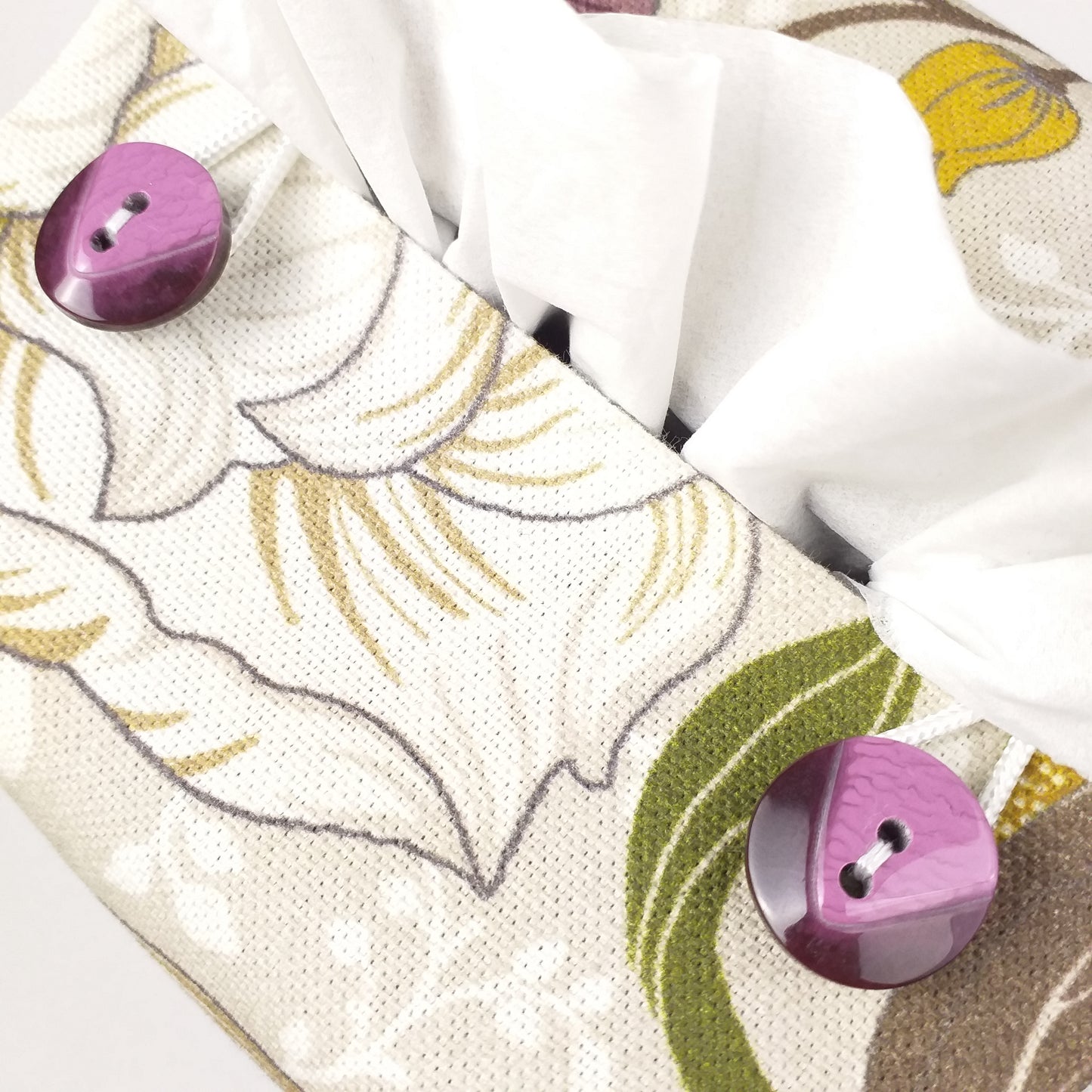 Close up view of square tissue box cover with buttons