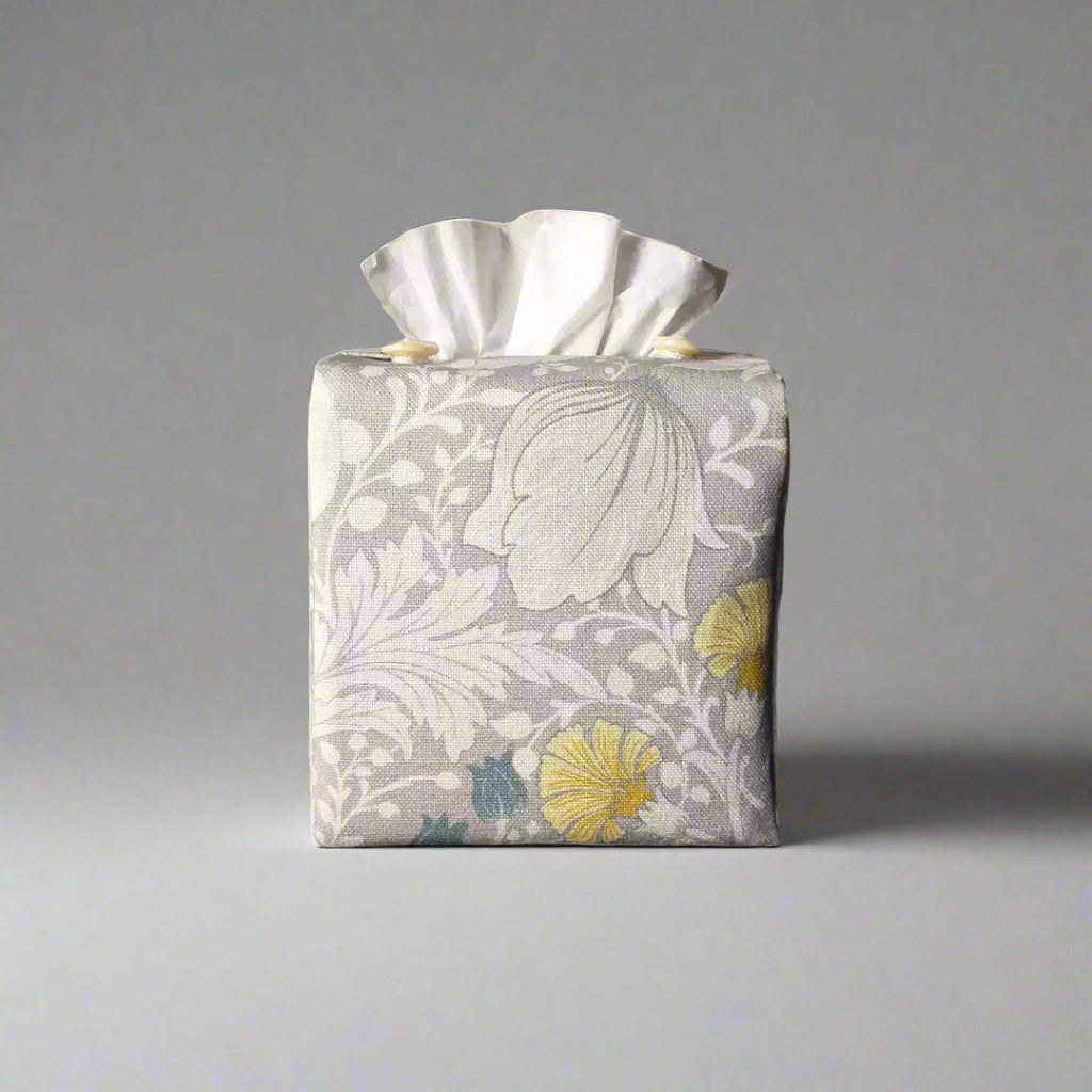 Square tissue box cover with white magnolia flowers design with blue, yellow, and grey accents