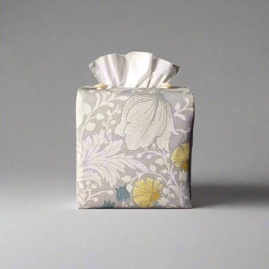 Square tissue box cover with white magnolia flowers design with blue, yellow, and grey accents