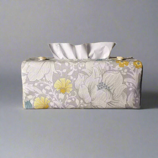 Rectangle tissue box cover with white magnolia flowers design with blue, yellow, and grey accents