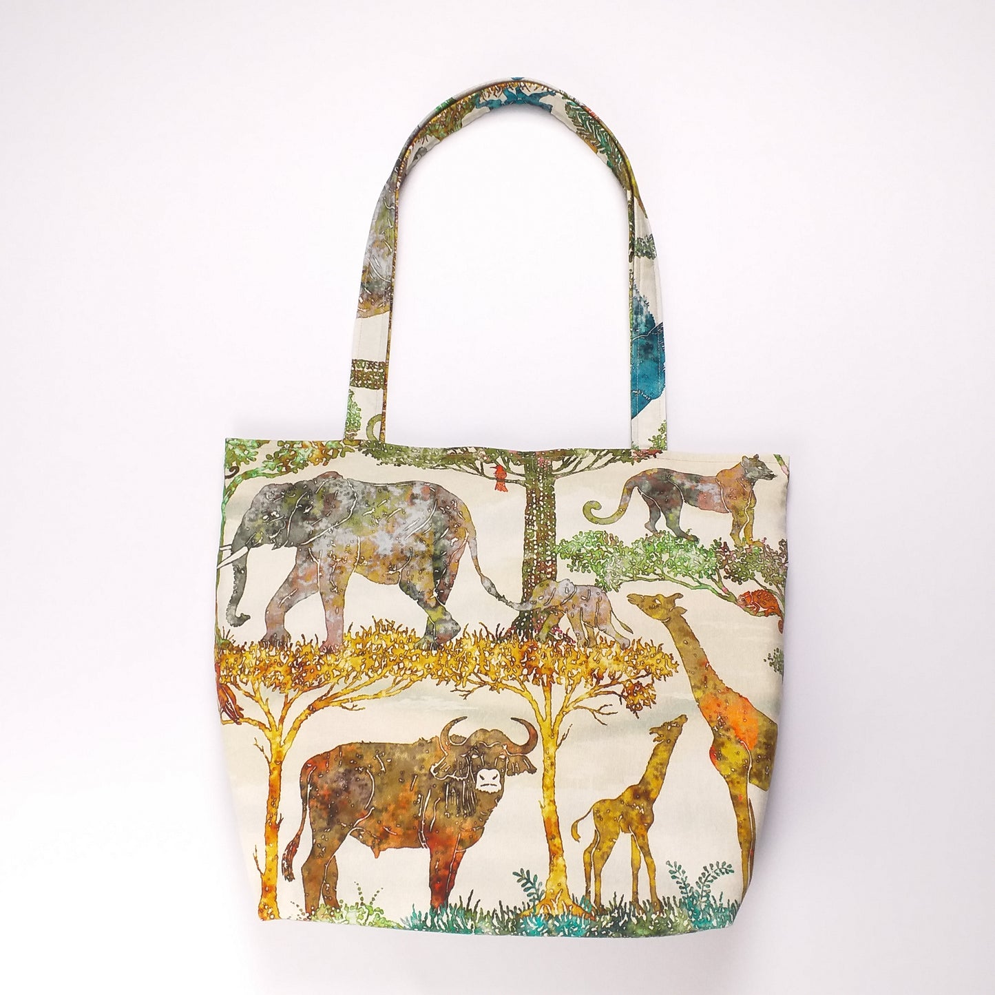Front view of a large cotton tote bag with elephant, giraffe, water buffalo, monkey, panther, gorilla, lemur, rhinoceros design
