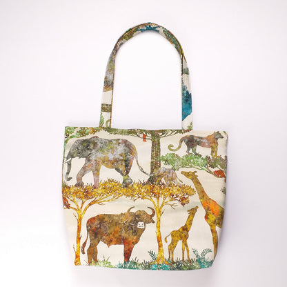 Front view of a large cotton tote bag with elephant, giraffe, water buffalo, monkey, panther, gorilla, lemur, rhinoceros design