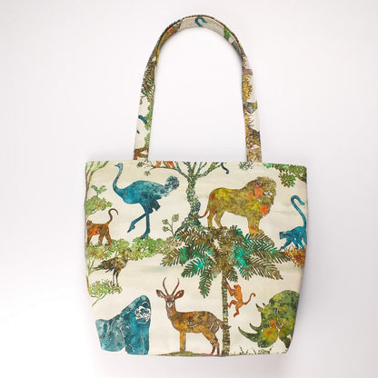 Back view of a large cotton tote bag with elephant, giraffe, water buffalo, monkey, panther, gorilla, lemur, rhinoceros design