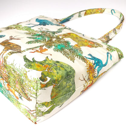 Bottom view of a large cotton tote bag with elephant, giraffe, water buffalo, monkey, panther, gorilla, lemur, rhinoceros design