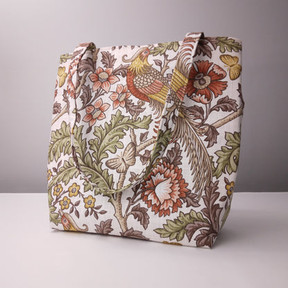 Side view of a large tote bag with pheasants and flowers design on natural colour background