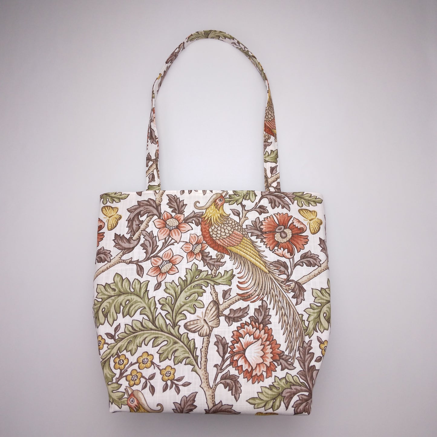 Front view of a large tote bag with pheasants and flowers design on natural colour background