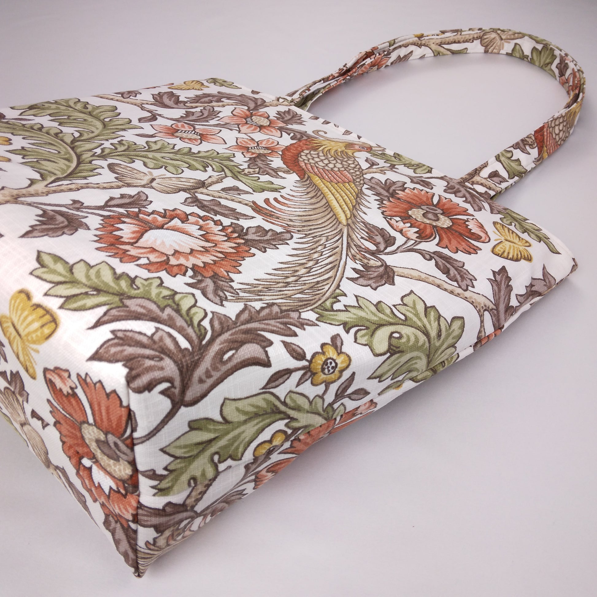 Bottom view of a large tote bag with pheasants and flowers design on natural colour background