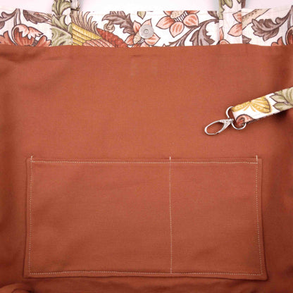 Close up view of a large tote bag interior slip pocket and key clasp