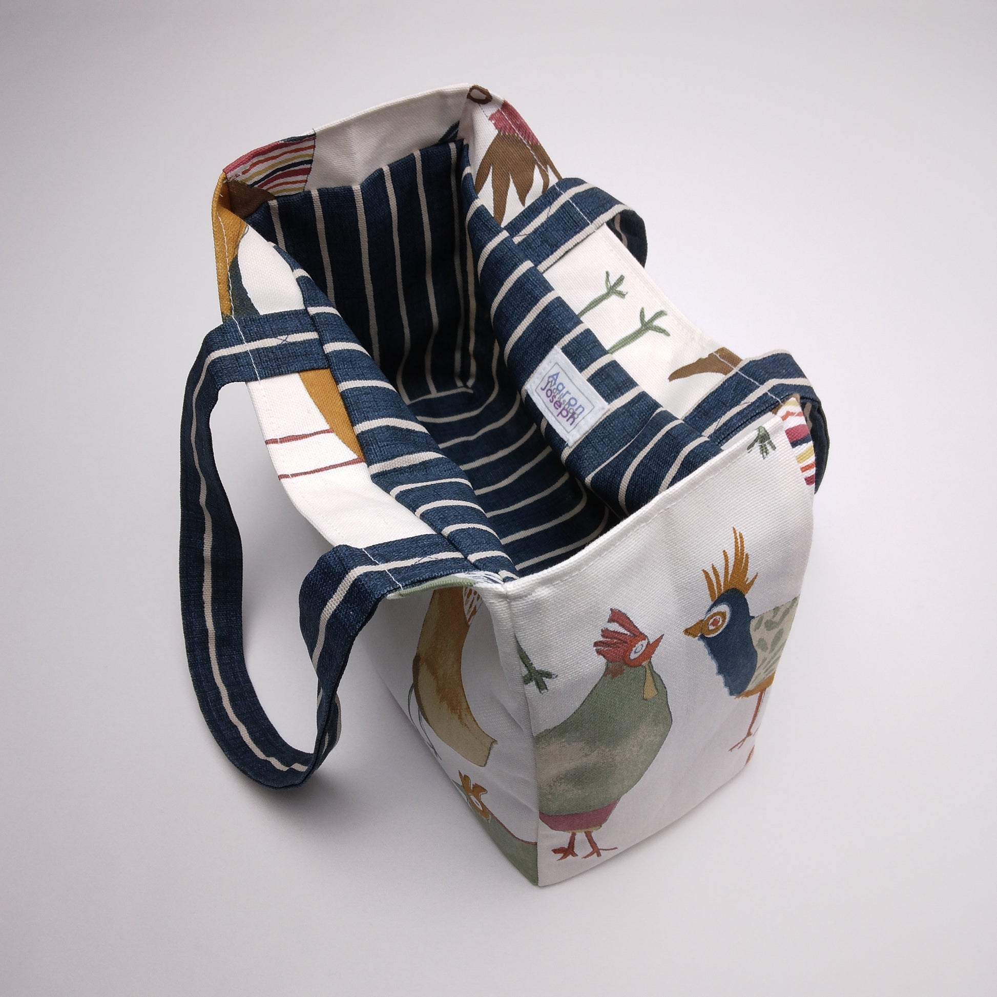 Mini tote bag with multi-colour hens design on beige background