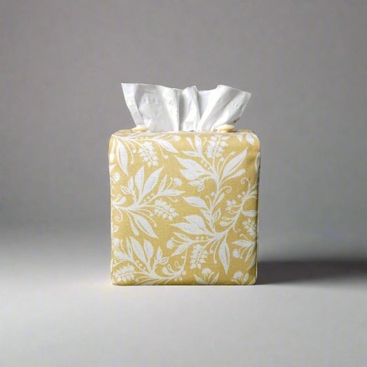 Square tissue box cover with white wildflower pattern on yellow background