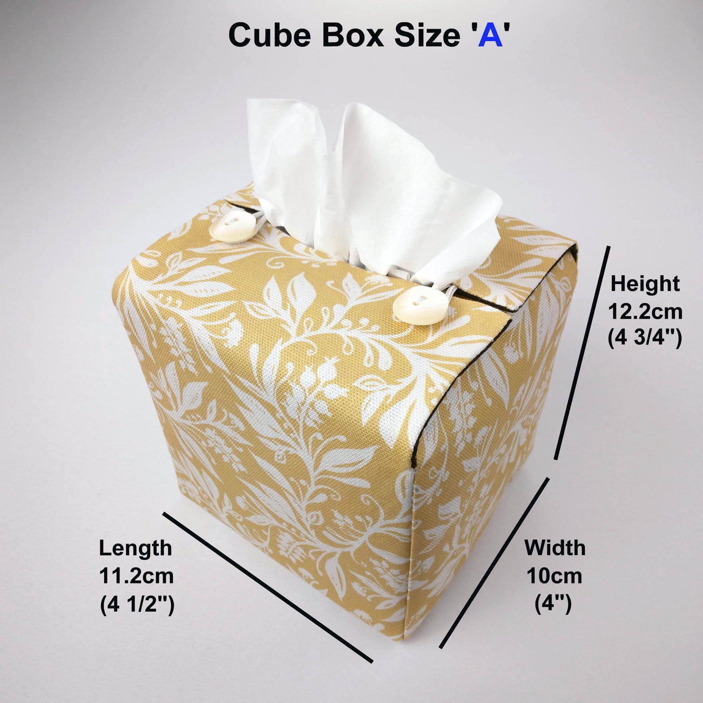 Square tissue box cover with white wildflower pattern on yellow background