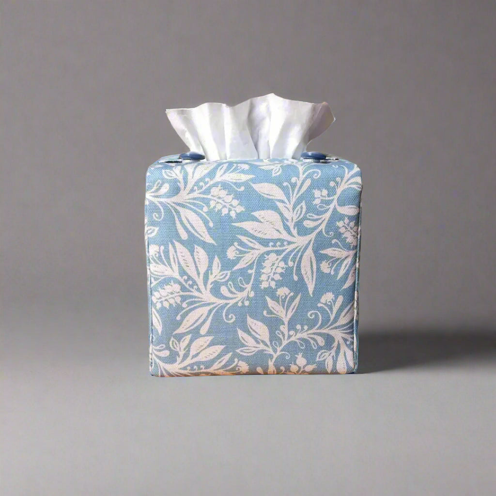 Square tissue box cover with white wildflower pattern on light blue background