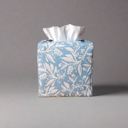Square tissue box cover with white wildflower pattern on light blue background