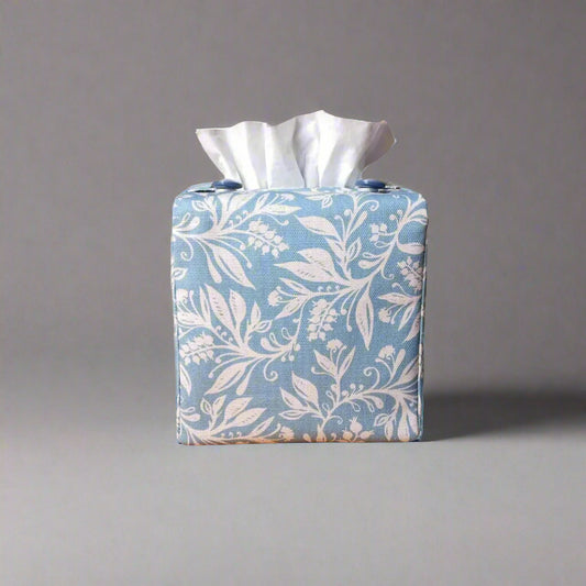 Square tissue box cover with white wildflower pattern on light blue background