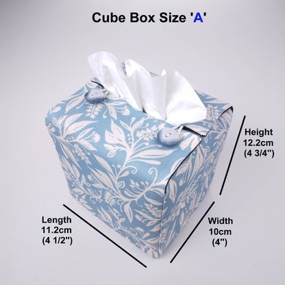 Square tissue box cover with white wildflower pattern on light blue background