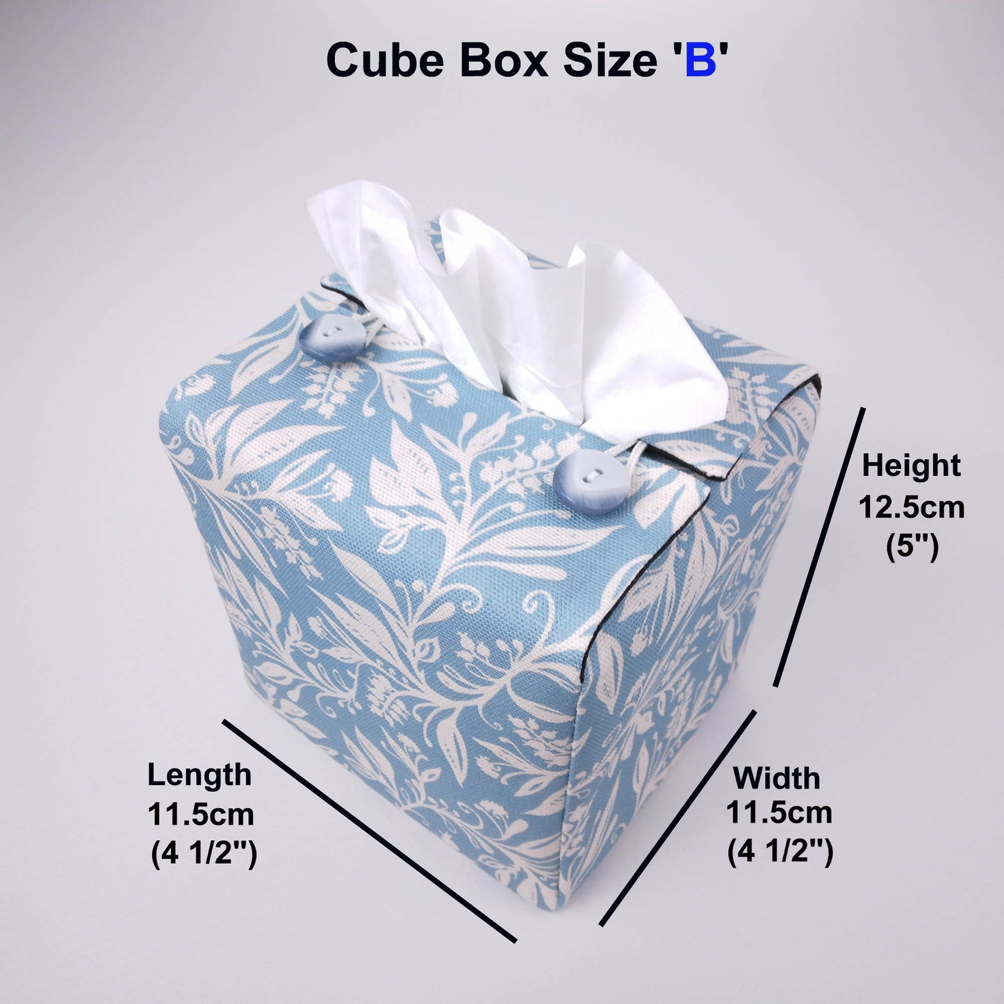 Square tissue box cover with white wildflower pattern on light blue background