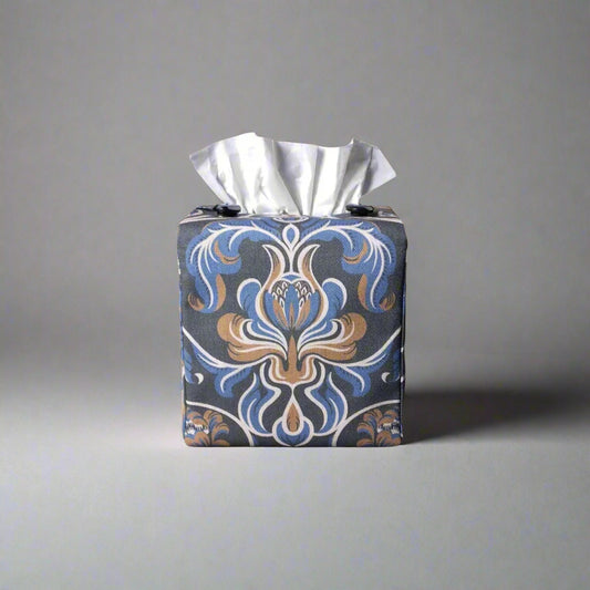 Square tissue box cover with white, brown, and blue baroque style floral design on navy background