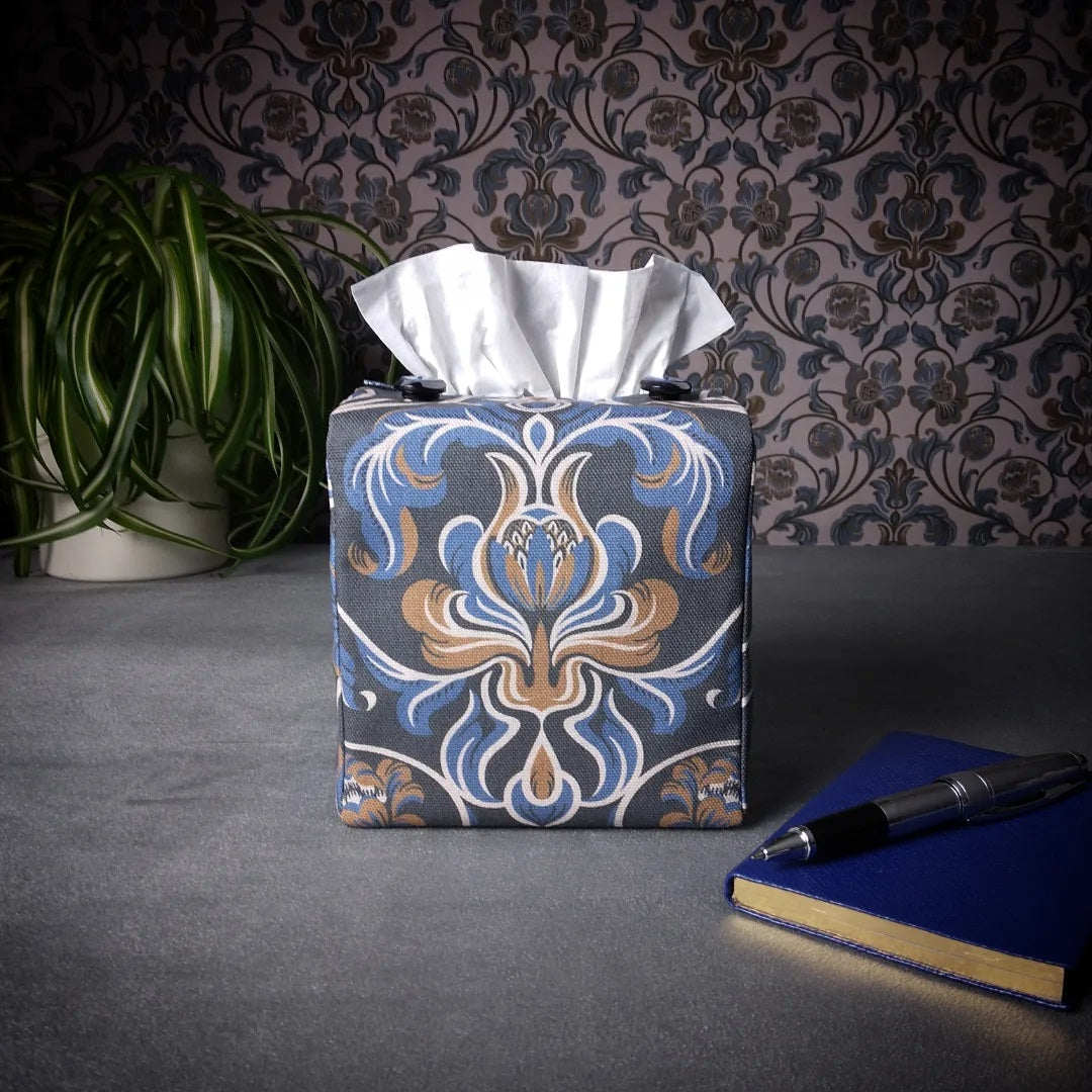 Square tissue box cover with pen, notebook, and plant